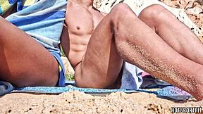Hot athletic couple flashes mutual masturbation handjob on public beach