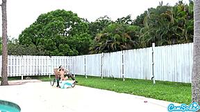 Teen lesbians engage in playful tug-of-war with a drone outdoors.