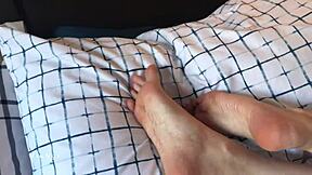 Bare feet in bed with Mianyx teasing toes and blue pedicure