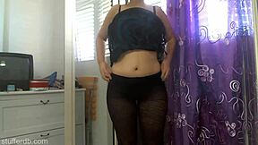 Oh wow, look at this sexy thick girl showing off her growing belly and big ass in pantyhose, it's so fetishy and chubby!