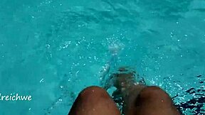 Young Amateur Plays with Feet in Pool