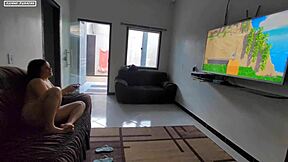 teen sits on lap playing game, feels huge cock