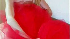 odette cavorts on her red bed, teasing her small tits and pussy