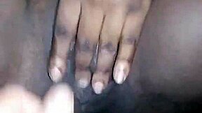 Young ebony teen fingers her wet pussy open