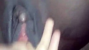 Young ebony teen fingers her wet pussy open