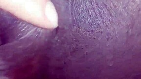 Young ebony teen fingers her wet pussy open