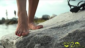 giggles feet rub all over a giant hot rock at the beach