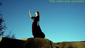 Watch her big tits bounce as she plays on the rock?