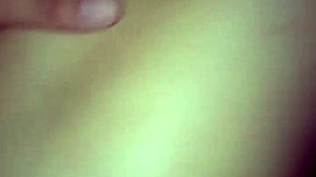 A young woman enjoys intimate moments in a private setting