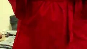 brunette in red lingerie teases with her big assets.