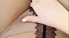 Teen achieves orgasm through pantyhose masturbation outdoors