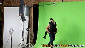 A young blonde teen engages in a hardcore activity with a huge black partner in doggystyle