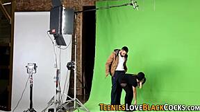 A young blonde teen engages in a hardcore activity with a huge black partner in doggystyle