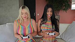 Brunette and blonde eat pussy during gaming