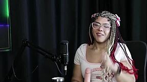 Sofie Lollipop teases with sheer red lingerie, kisses presenter, and shows blowjob skills in group fun 😏