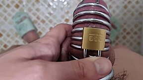 Asian guy pees while locked in chastity belt