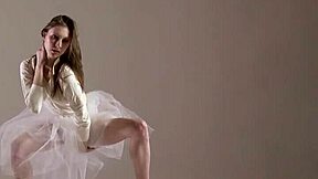 Blonde gymnast stretches in gym. Russian fitness on display.