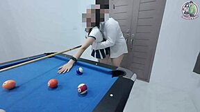 thai girl in uniform climbs pool table for fun game in dorm