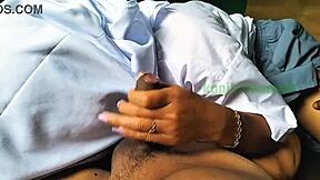 Asian couple practicing handjob techniques outdoors in a homemade video.