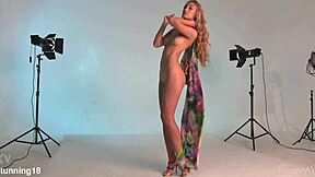 blonde teen 18+ with bright hazel eyes stands nude here