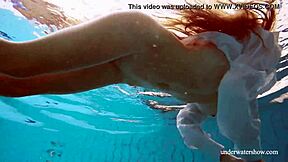 Lola shows her big natural tits while swimming underwater.