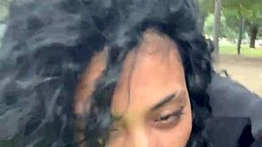 A person drinks milk in a public park in Buenos Aires during the day