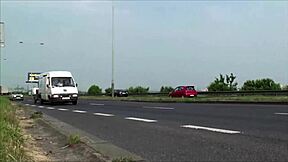 Busty girl participates in a public threesome by the highway