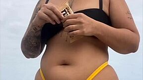 look at my swollen pussy in tight yellow bikini on beach