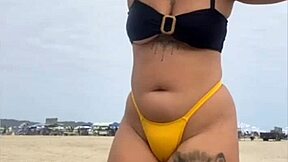 look at my swollen pussy in tight yellow bikini on beach