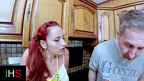 Redhead teen masturbates with fruit and dildos in kitchen before riding cock