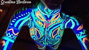 Wild slim brunette girl with long hair gets fucked doggystyle by big cock in UV light.