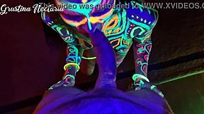 Wild slim brunette girl with long hair gets fucked doggystyle by big cock in UV light.