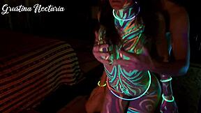 Wild slim brunette girl with long hair gets fucked doggystyle by big cock in UV light.