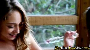 Teen lesbians in stockings kiss and toy their tight ass holes with beads