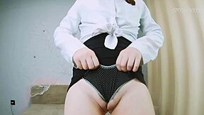 Petite secretary teases with mini skirt, crossed long legs, upskirt flashes, and tight wedgie views.