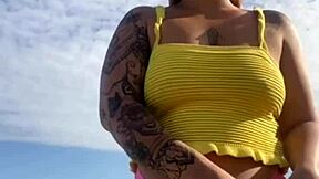 Hey, check out this young exhibitionist flashing her puffy pussy lips in bikini at the beach