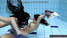 shaved brunette babe with big tits teases subtly in underwater pool bathing session with tight body