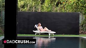 I'm teasing my horny stepdad by the pool, fingering my tight pussy until he notices