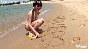 skinny japanese chick poses in bikini during outdoor photoshoot on the beach with close up shots