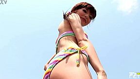 skinny japanese chick poses in bikini during outdoor photoshoot on the beach with close up shots