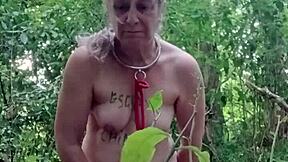 Slave maid in bondage gets handcuffed and fucked doggystyle with dildo in public outdoor humiliation.