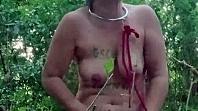 Slave maid in bondage gets handcuffed and fucked doggystyle with dildo in public outdoor humiliation.