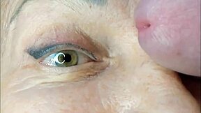 Milf gets extreme close-up cumshot right on her eye during intense orgasm. She moans wildly in bedroom squirting session.