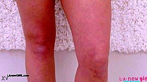 cute teen 18+ blonde model poses on sofa showing petite body in casting interview photoshoot