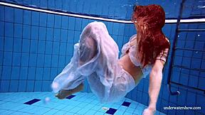 redhead marketa teases in white dress by the pool