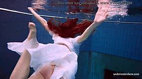 redhead marketa teases in white dress by the pool