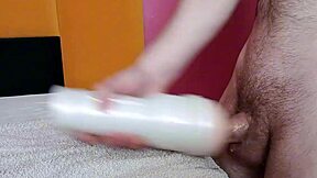 in a detailed close-up, the thick dick penetrates the fleshlight steadily during solo masturbation session