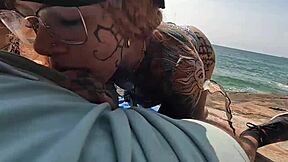 In a deserted beach, naughty girls engage in a hot orgy with kissing and cunilingus.