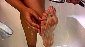 Blonde cutie teases with feet in bathtub, moaning softly by the pool.