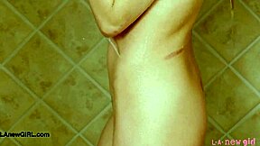 Stunning golden-haired model takes a shower after photoshoot on sofa with petite body